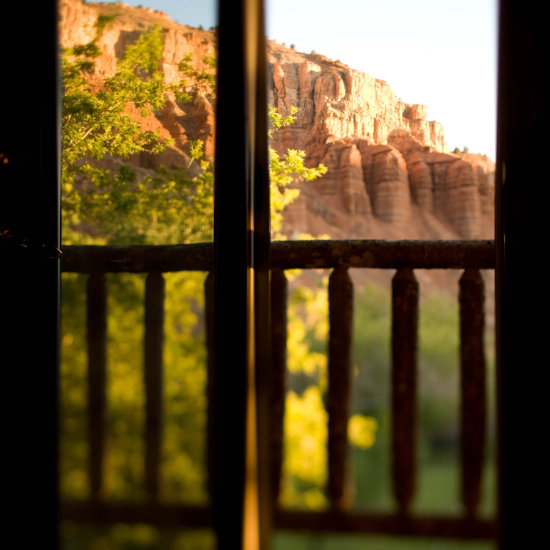 Looking out at the red cliffs from a guest room balcony