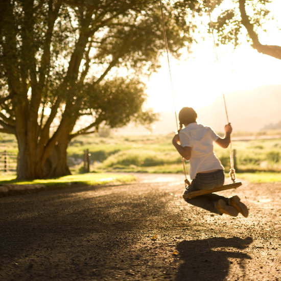 A girl swings on our tree swing