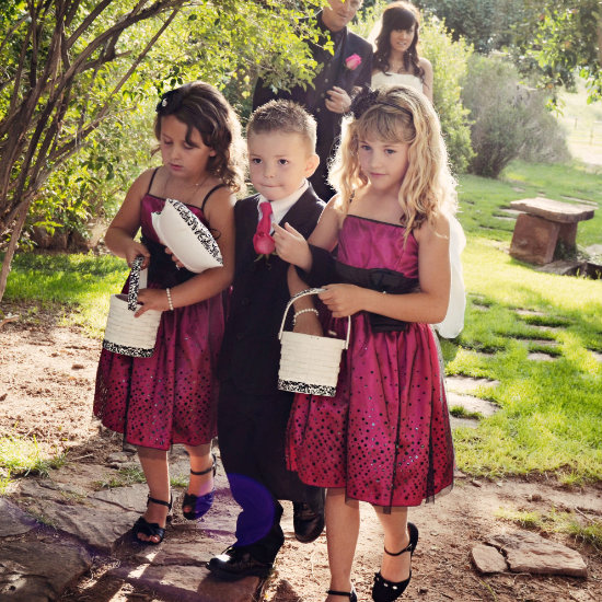 Children of the wedding party walk ahead of the bride