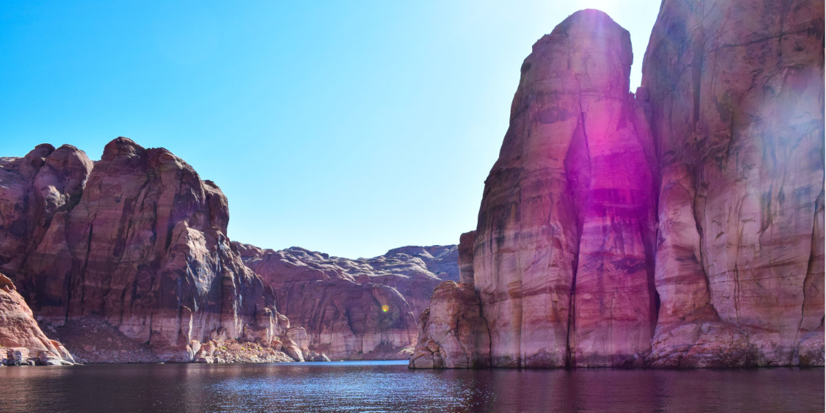 Desert lake with large sandstone cliffs