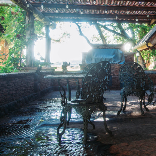 The dining area exterior patio close up of table and chairs