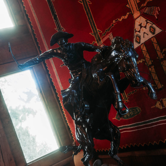 A close up of a bronze cowboy statue