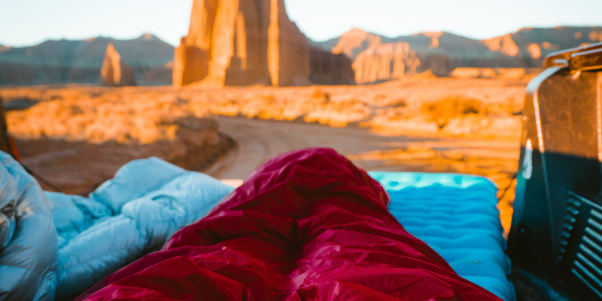 A camper rests with the Temple of Sun in Capitol Reef in the backgroung
