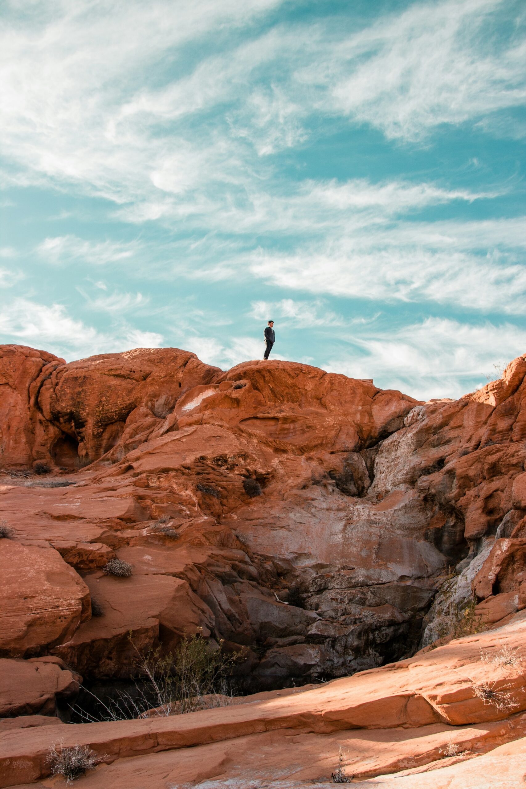 Family hiking a red rock canyon trail in Capitol Reef National Park in spring