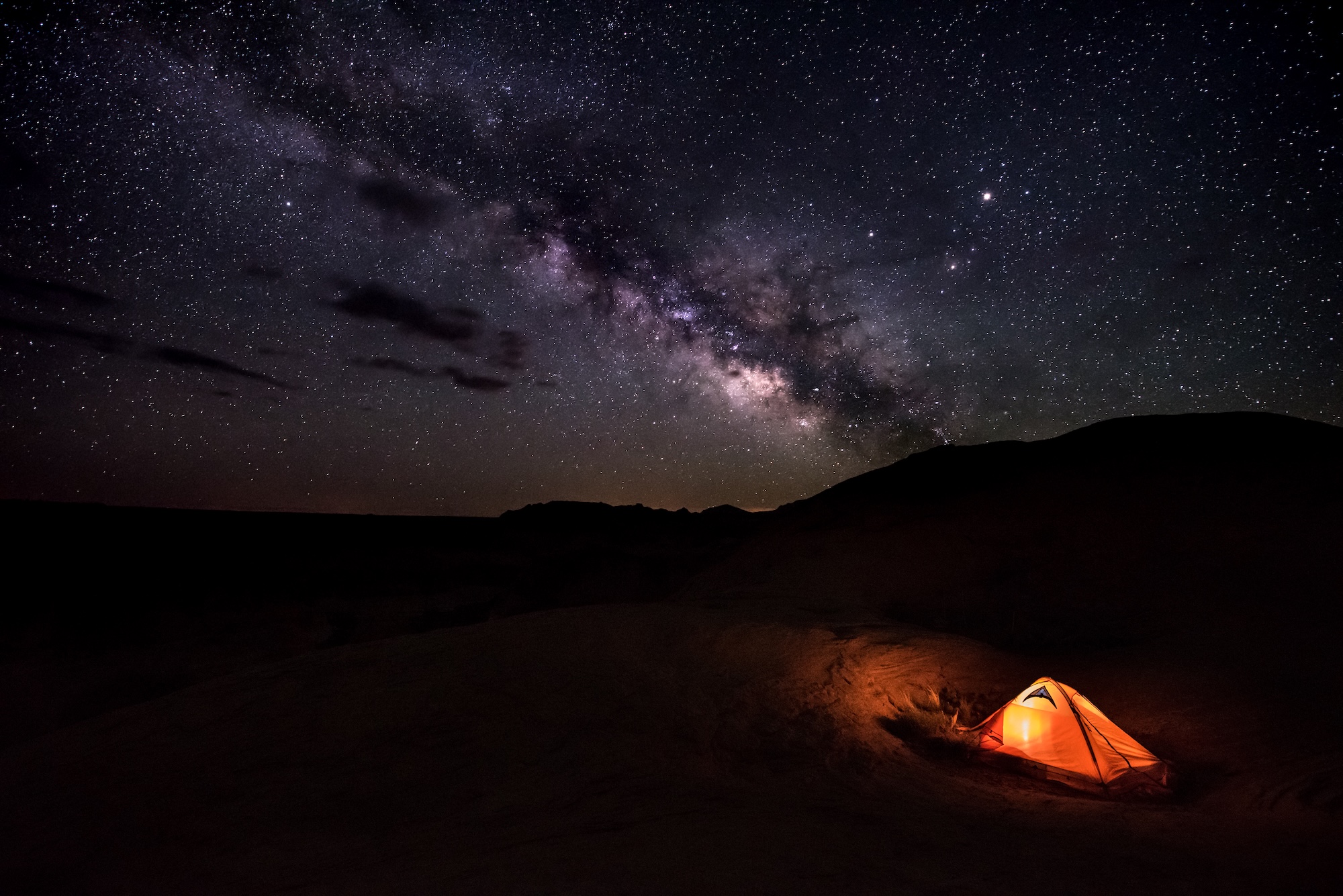 The Milky Way arching over a tent