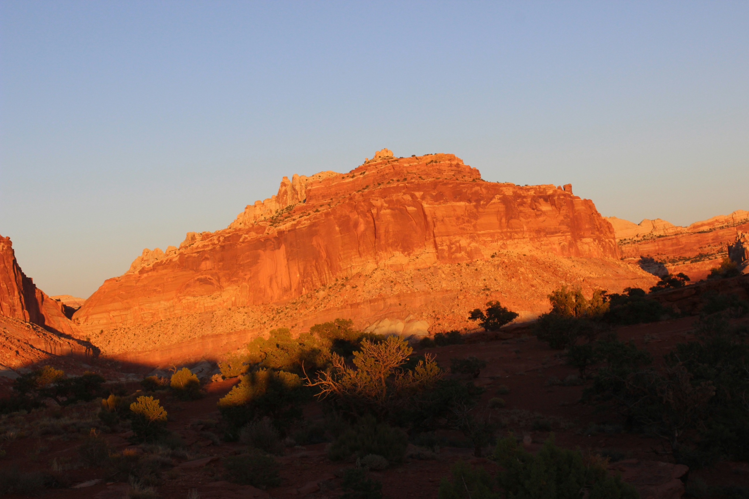 Morning light on red sandstone cliffs in Capitol Reef country