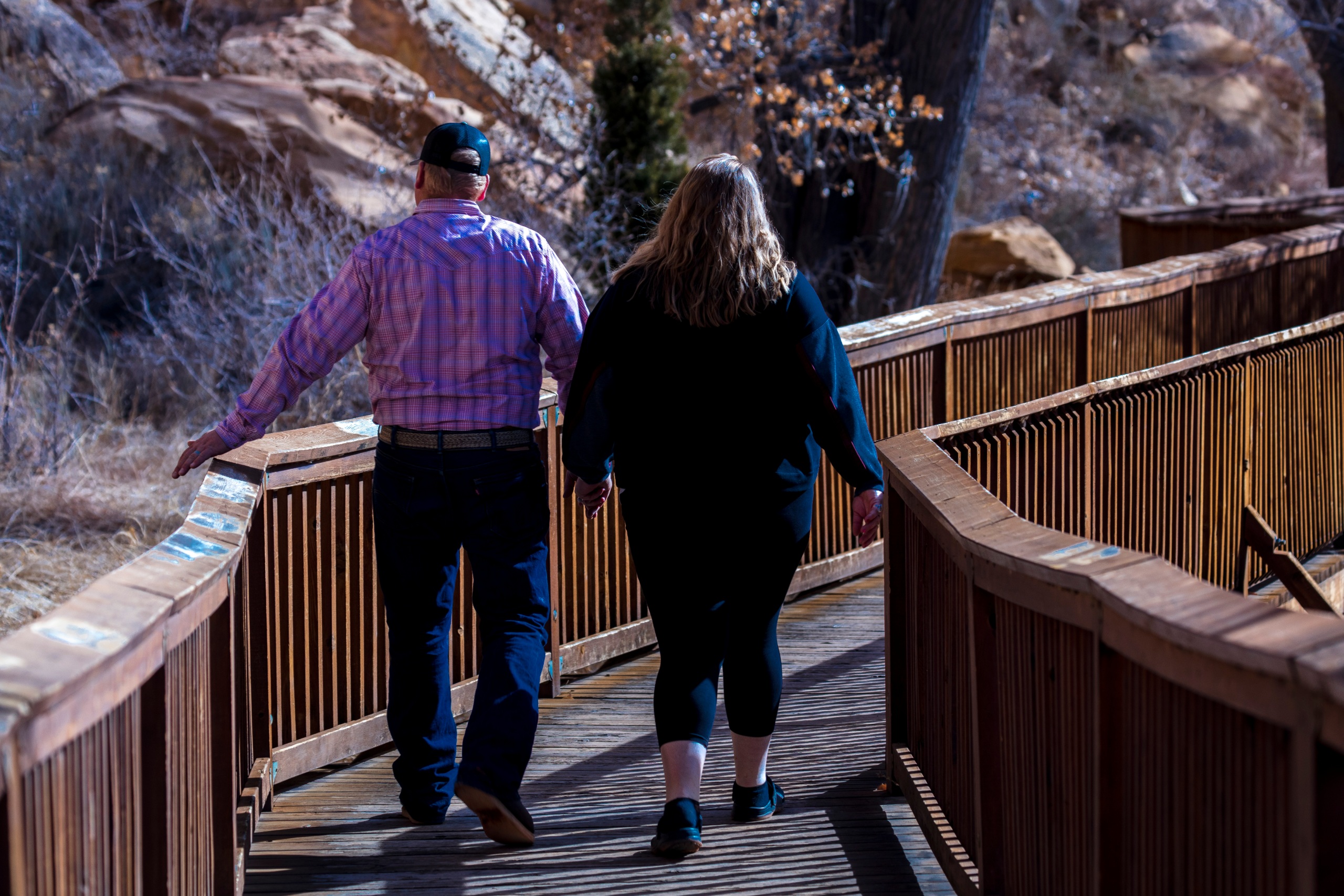 A boardwalk below red sandstone cliffs in Southern Utah
